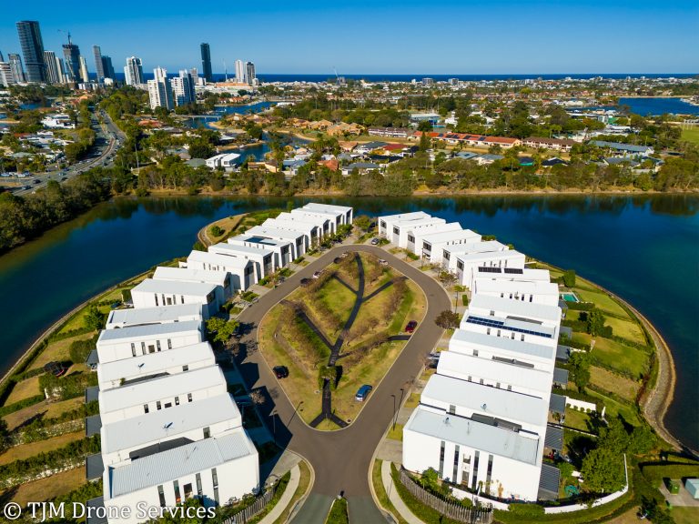 Aerial view of modern waterfront real estate, showcasing drone services, landscape and real estate photography.