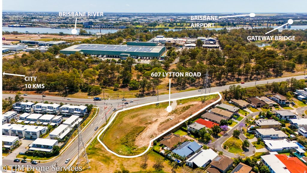 Aerial view of a commercial property for sale in the area of a city landscape showcasing drone services and drone real estate footage