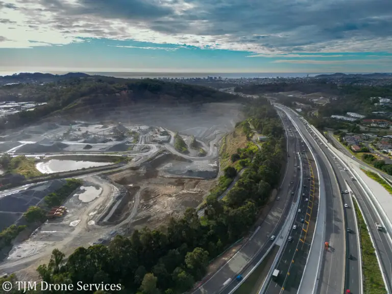 Aerial view of a major road bypassing a landfill quarry in the city of Gold Coast showcasing drone photography and drone video, aerial landscape photography and asset management using a drone