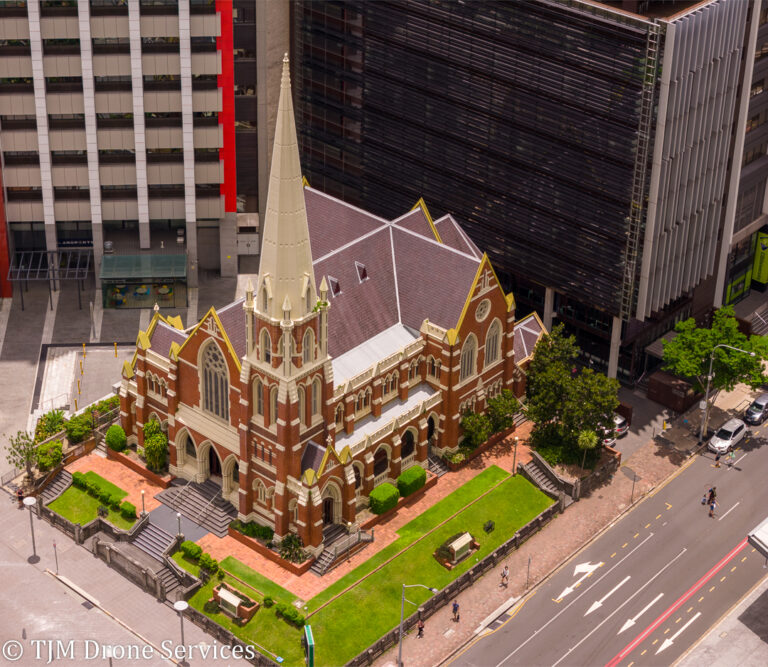 A church in the middle of a city surrounded by tall buildings showcasing drone services and drone photography